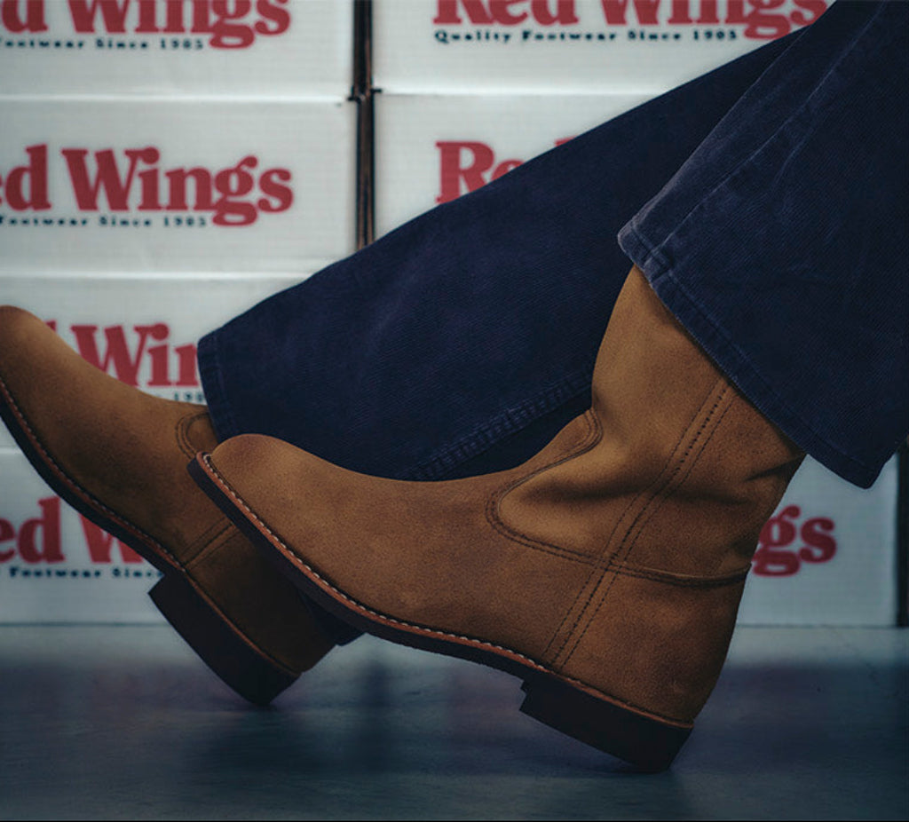 Brown boots with a visible brand logo on a white background