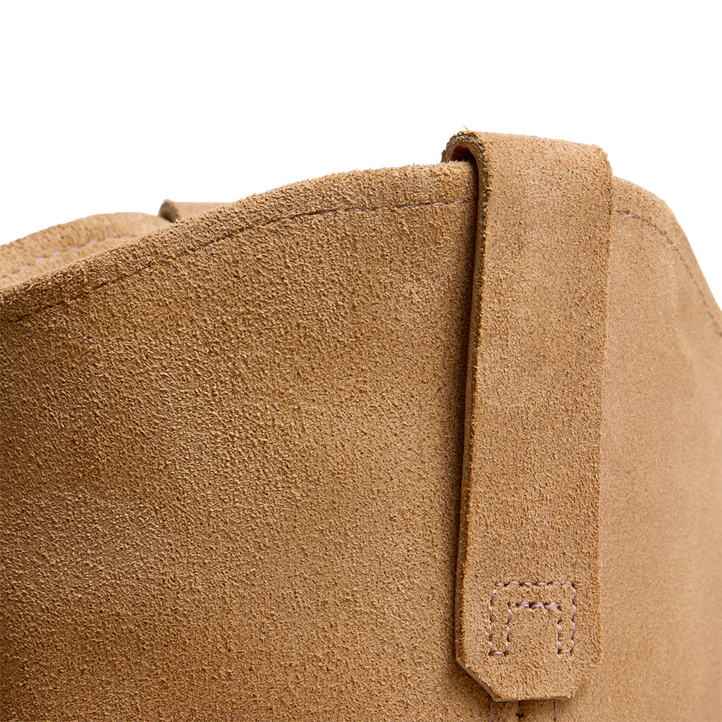 Close-up of a the rough out leather with a strap on a white background