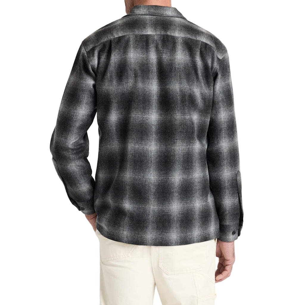 Man wearing a gray plaid shirt on a white background