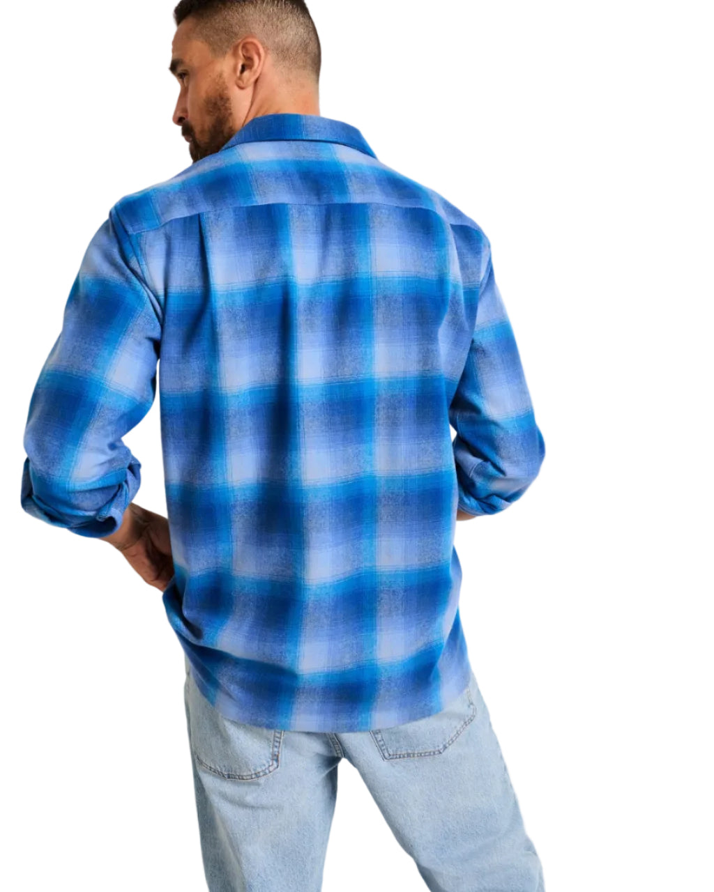 Man wearing a blue plaid shirt against a plain background