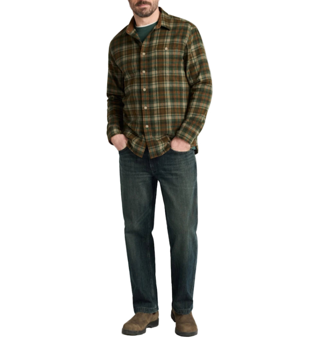 Man wearing a plaid shirt and jeans on a white background