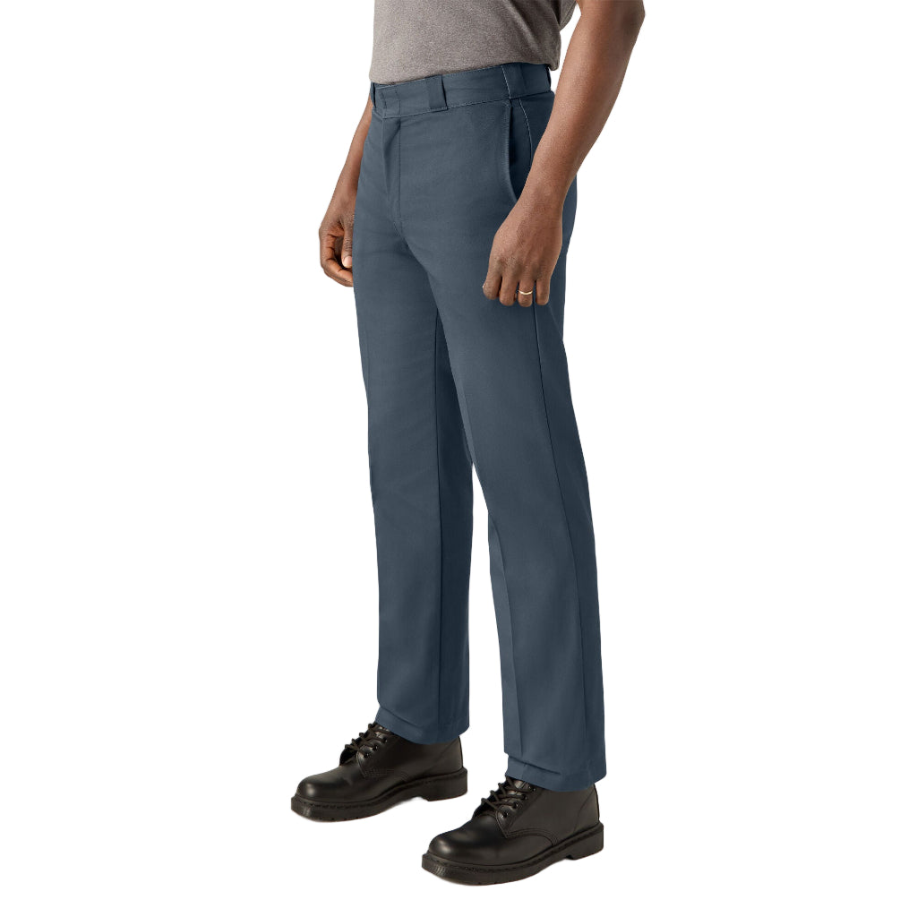 Person wearing blue pants and black shoes on a white background