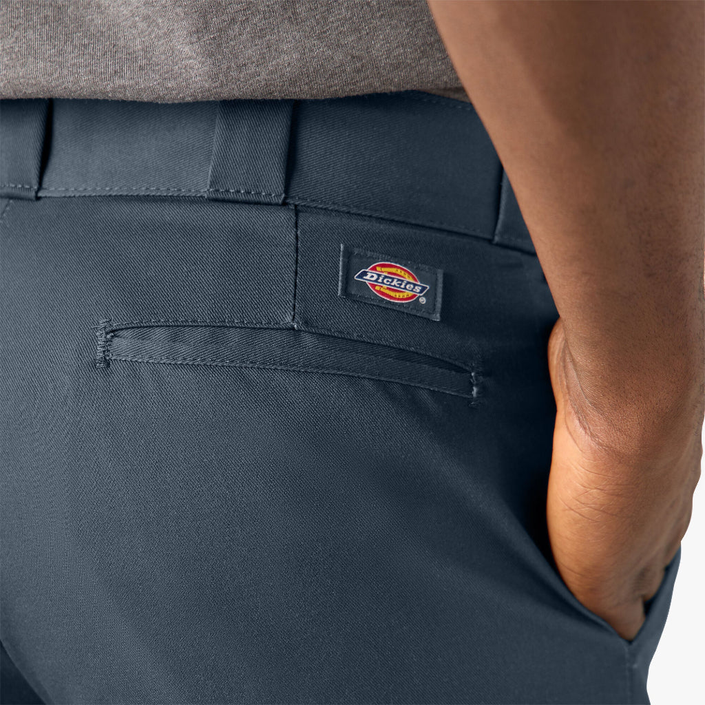 Navy blue pants with a Dickies logo on the pocket against a neutral background