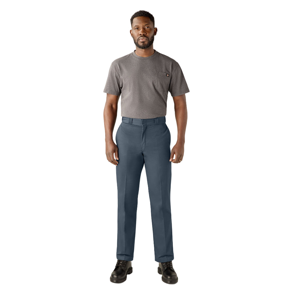 Man wearing a gray t-shirt and blue pants on a white background