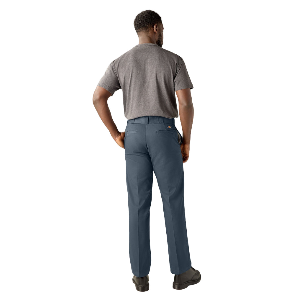 Man wearing gray t-shirt and blue pants on a white background