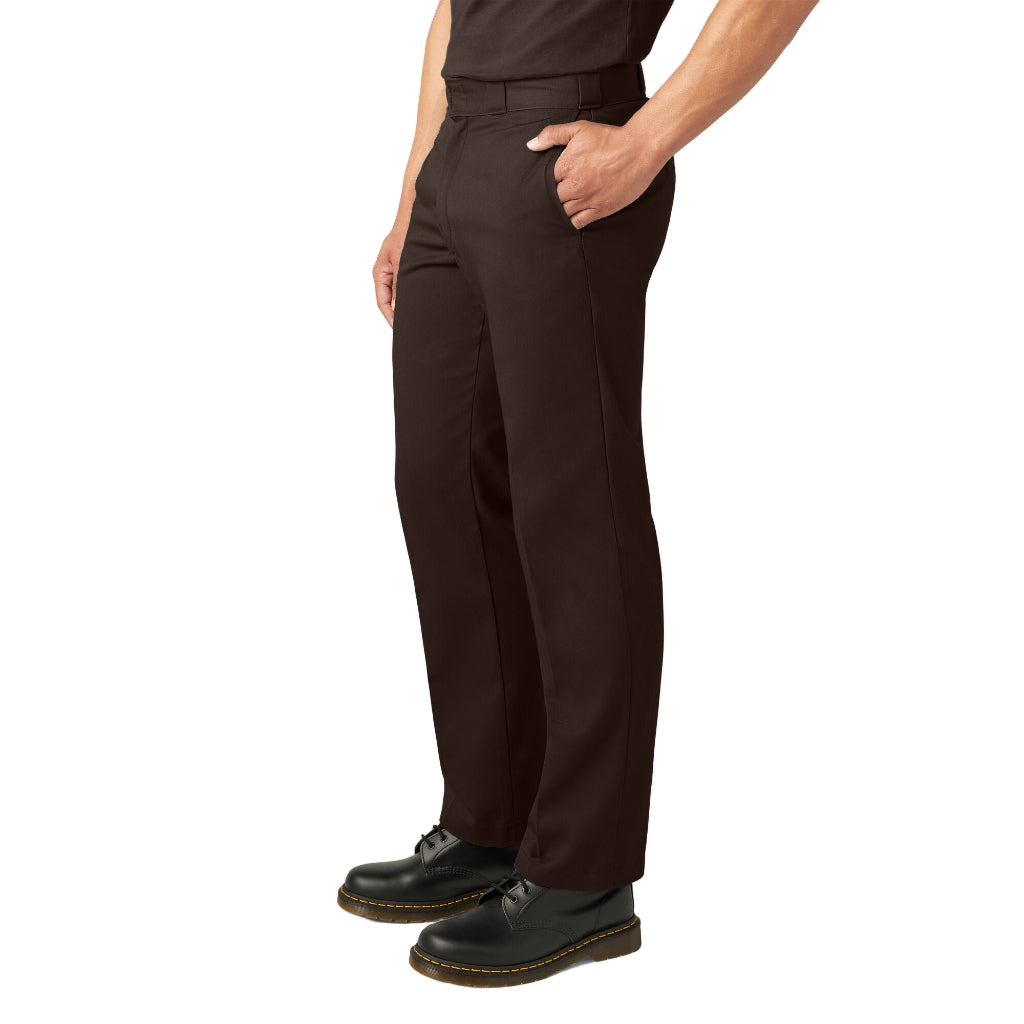 Person wearing dark brown pants and black shoes on a white background