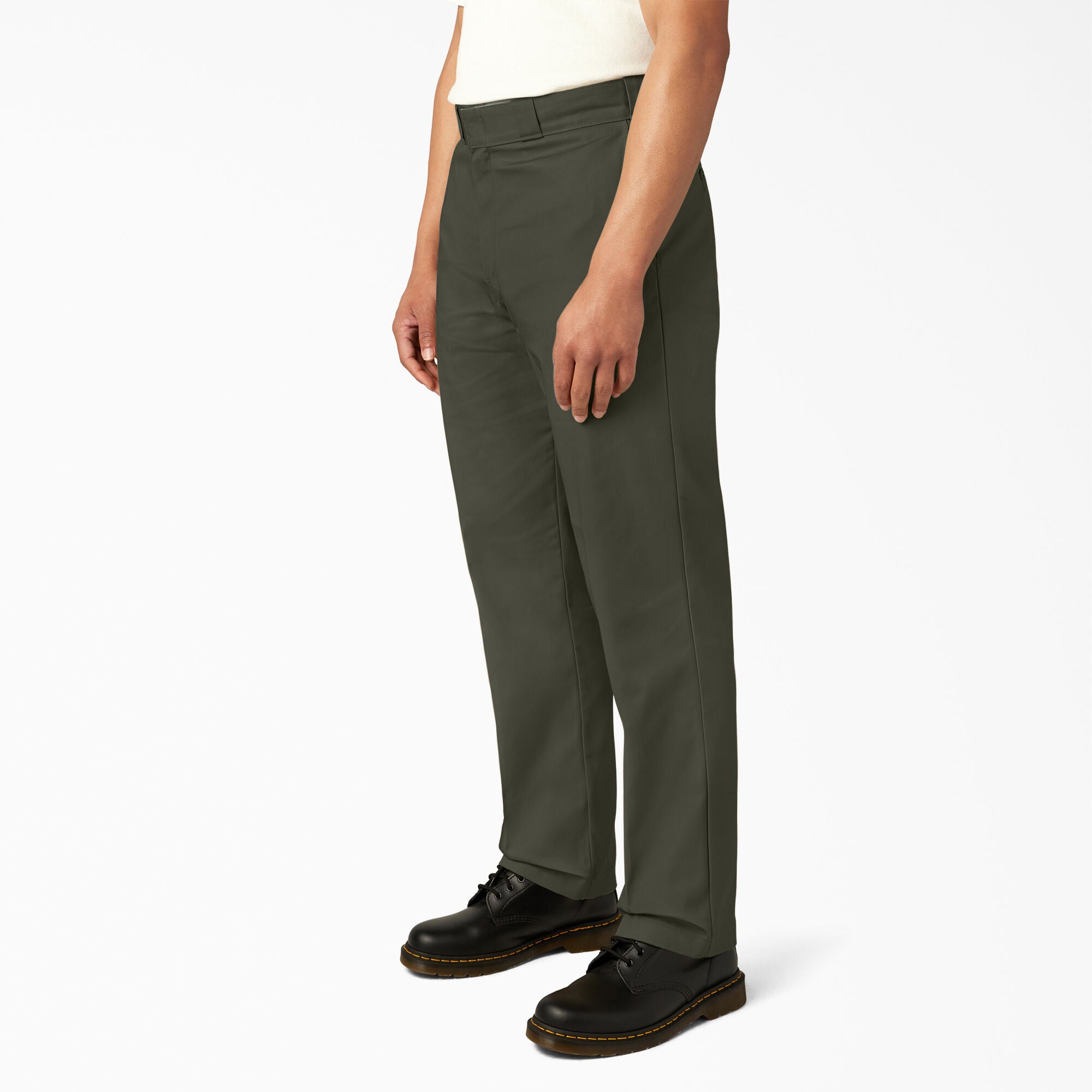Person wearing olive green pants on a white background