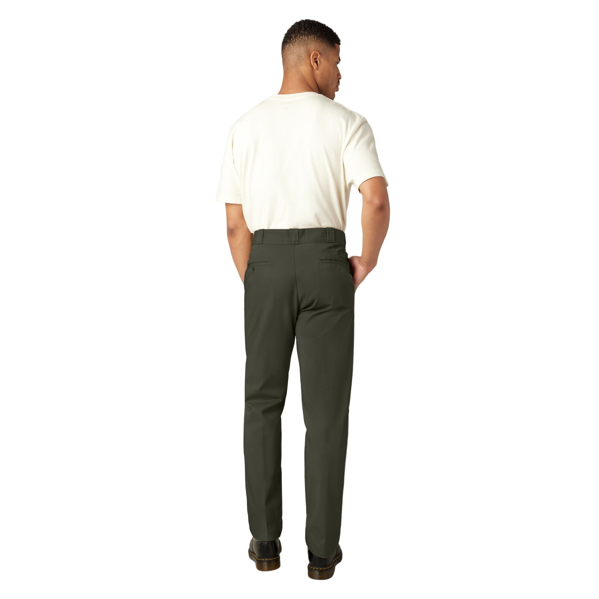 Man wearing a white shirt and green pants on a white background