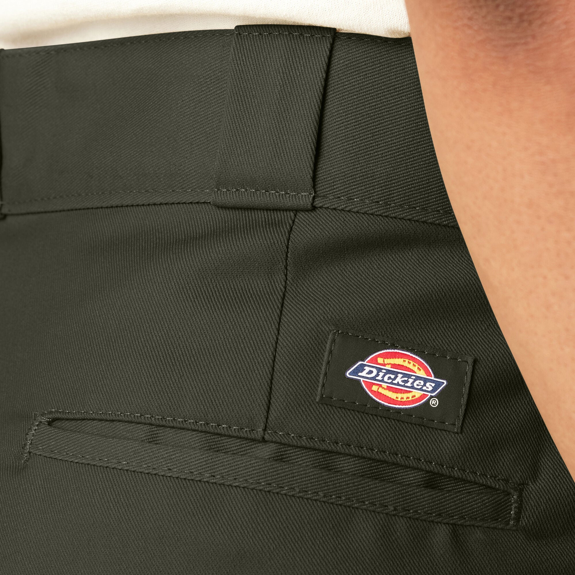 Dickies logo on a green work pants pocket