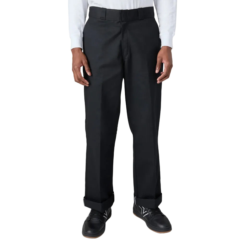 Black dress pants worn with a white shirt on a white background
