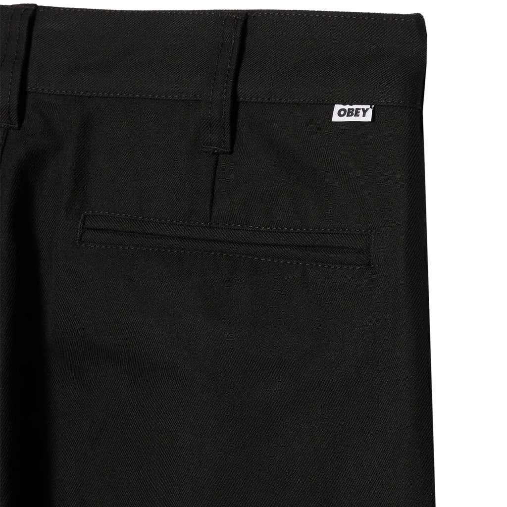 Black pants with a visible 'Obey' logo on a white background