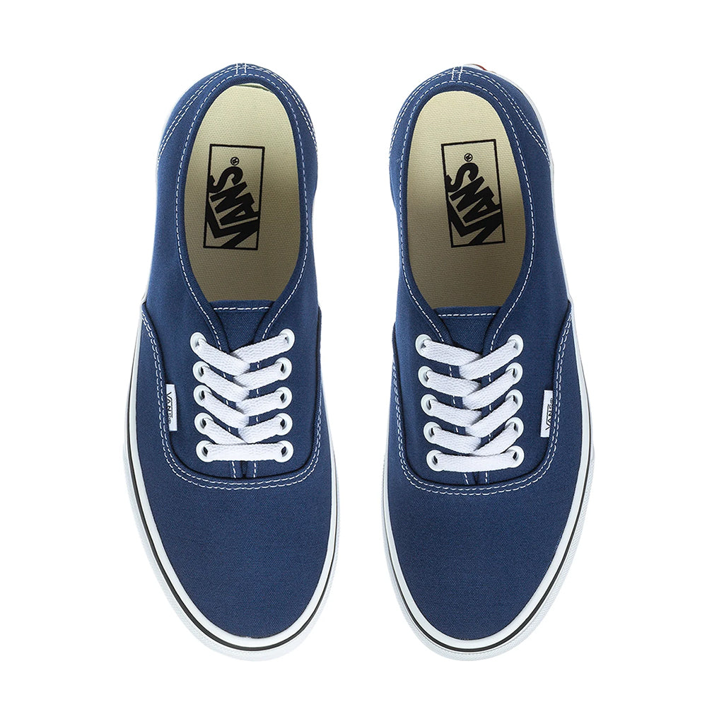 Pair of blue sneakers with white laces on a white background