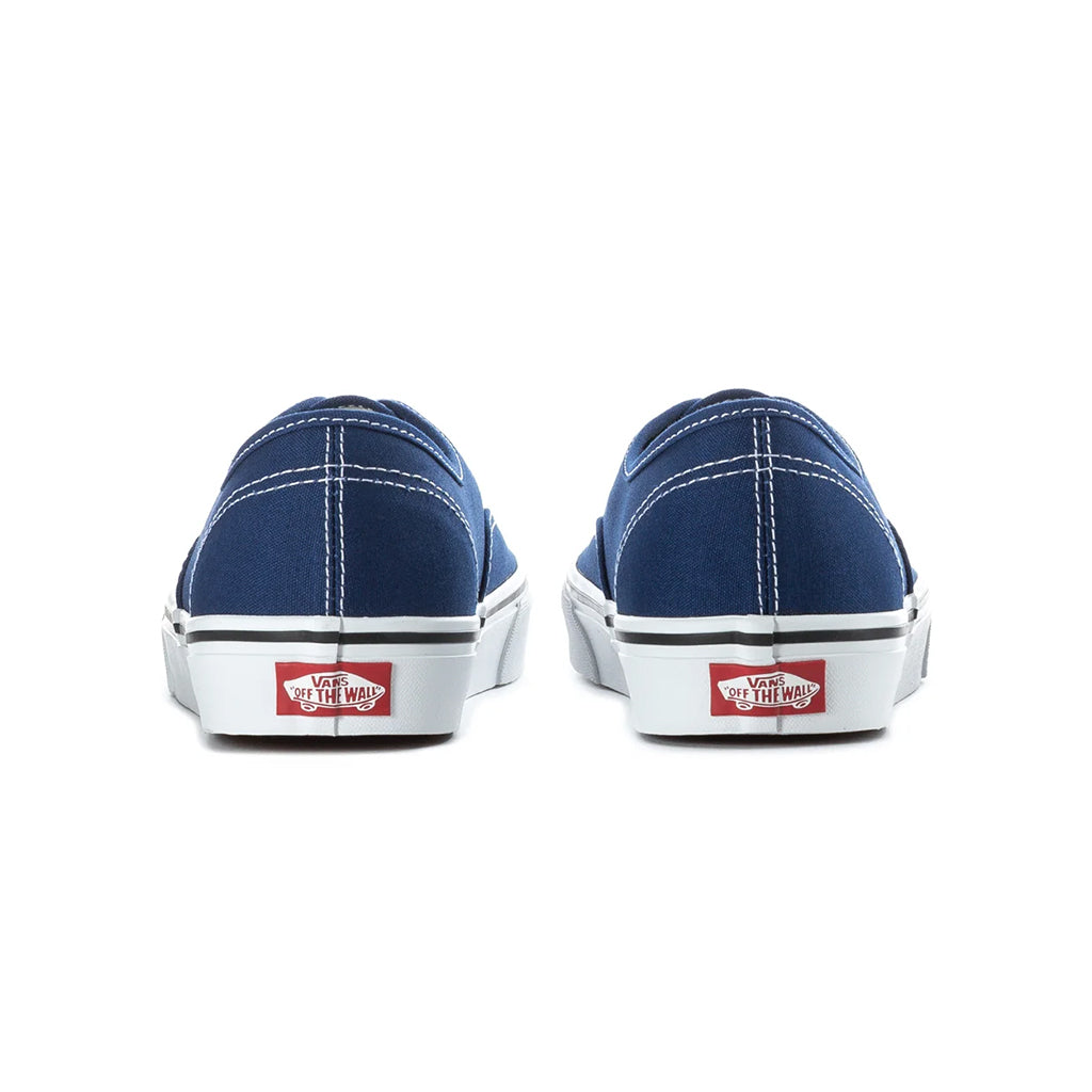 Pair of blue sneakers with white soles on a white background