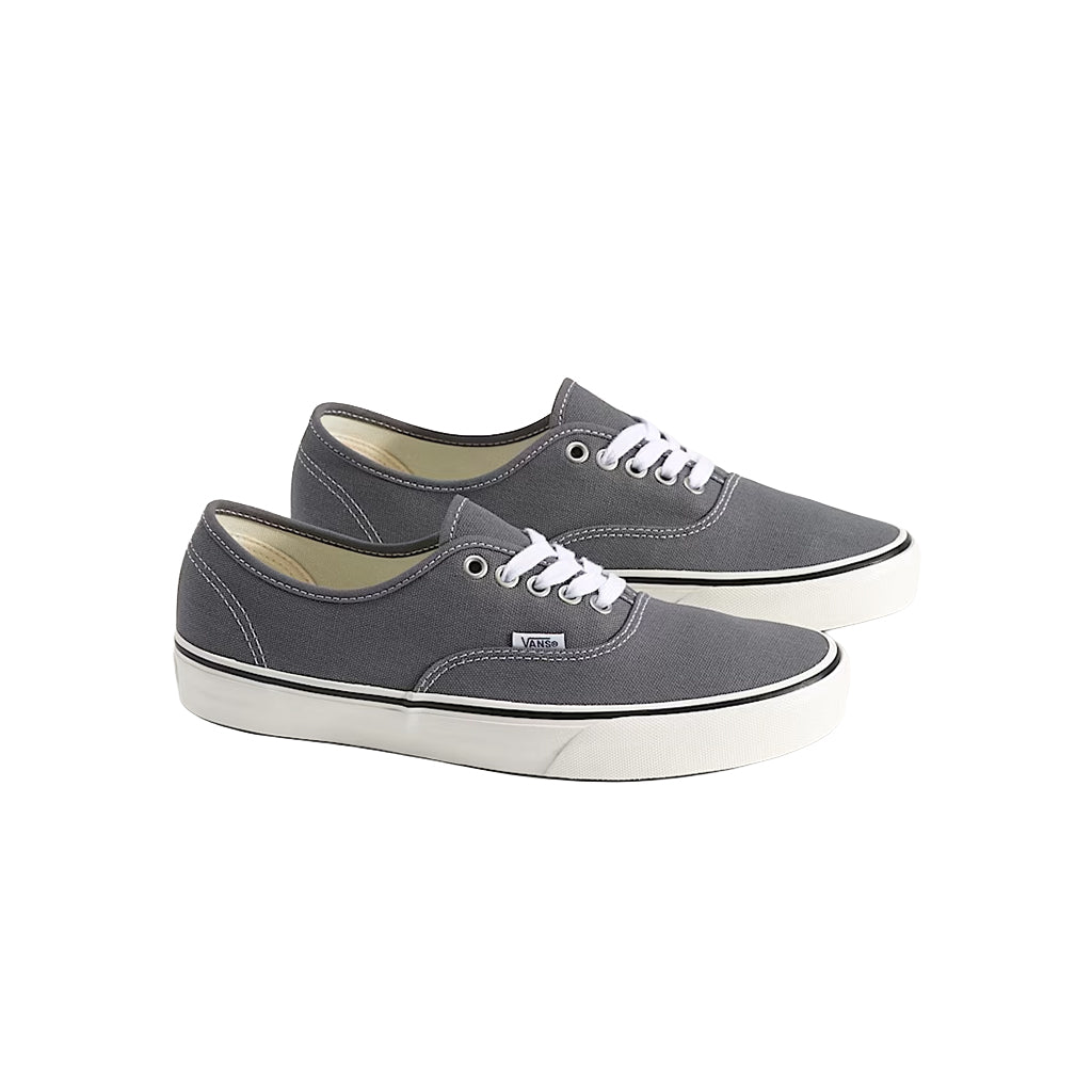 Pair of gray sneakers with white laces on a white background