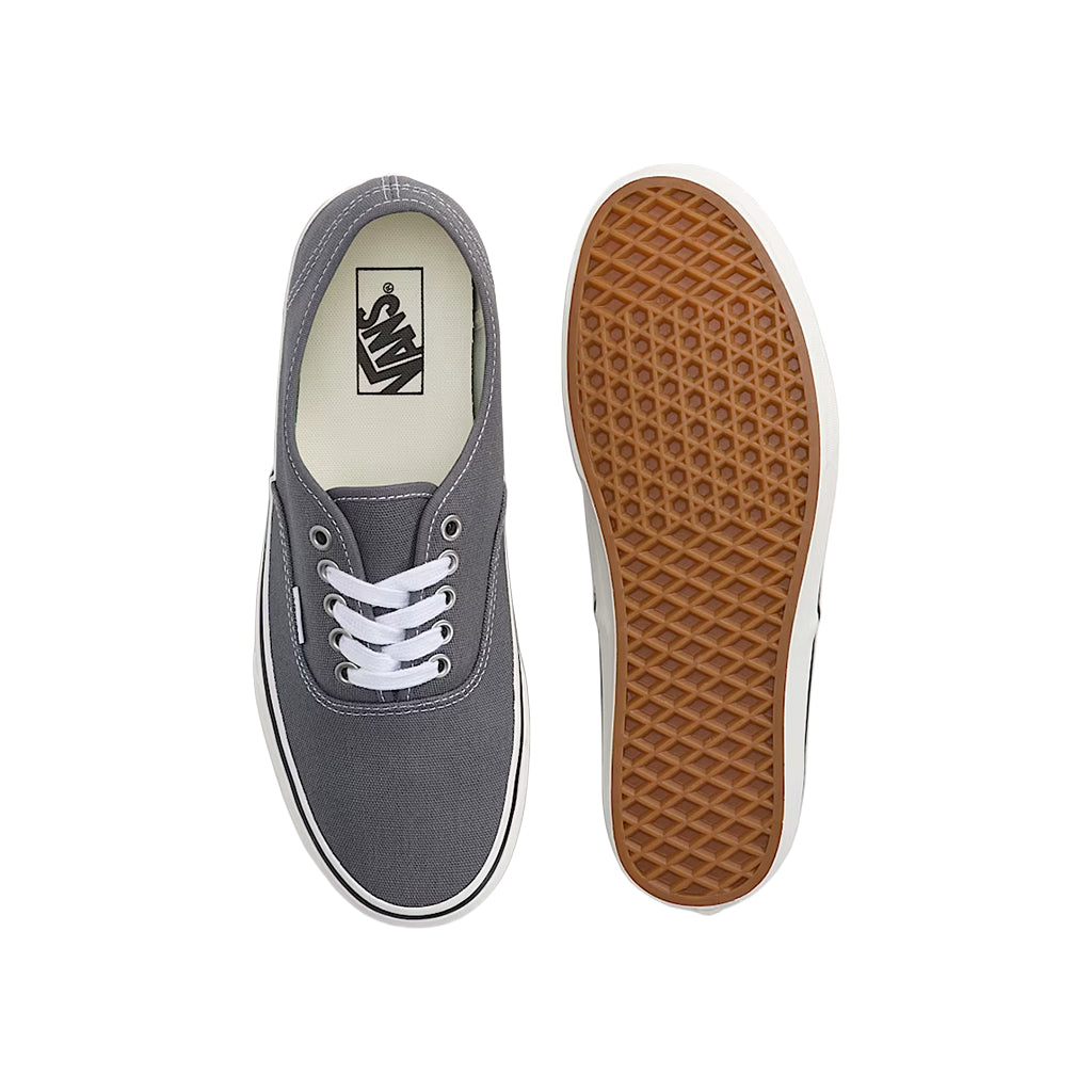 Gray sneaker with white laces and brown sole on a white background