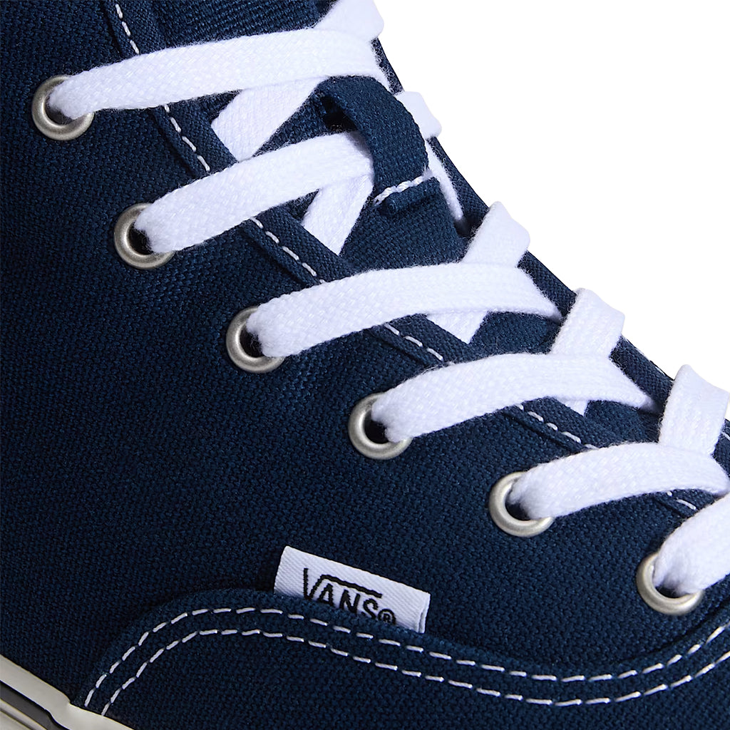 Navy blue high-top sneaker with white laces on a white background