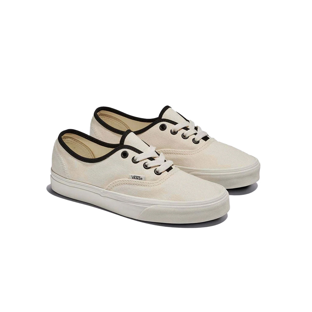 A pair of white Vans low-top sneakers with lace-up closure and rubber waffle outsoles.