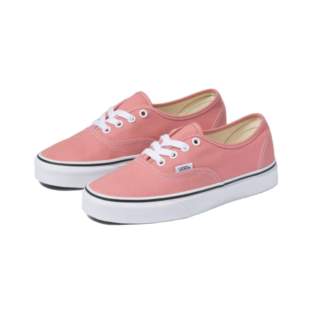 Pair of pink Vans sneakers on a white background