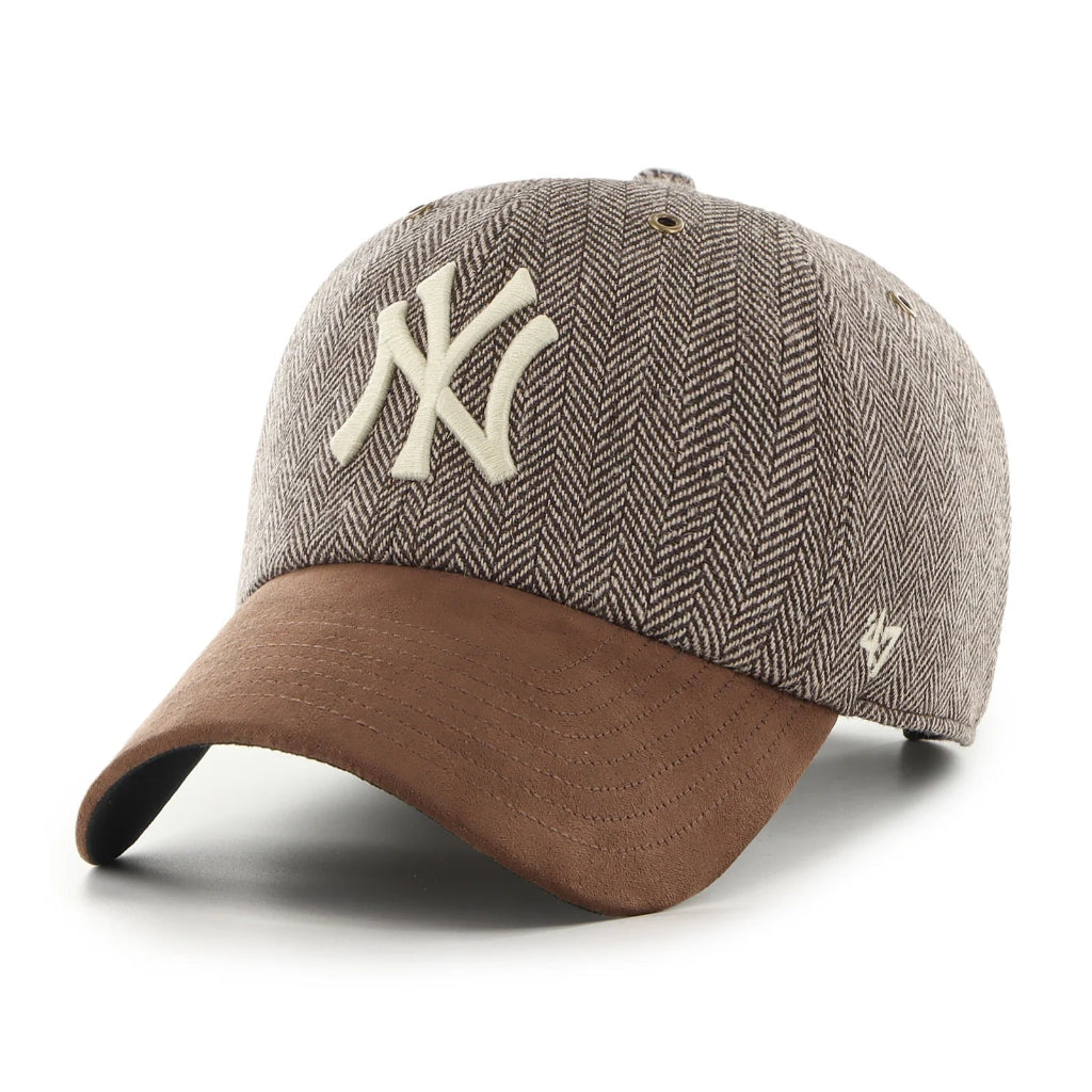 Baseball cap with herringbone pattern and brown brim on a white background