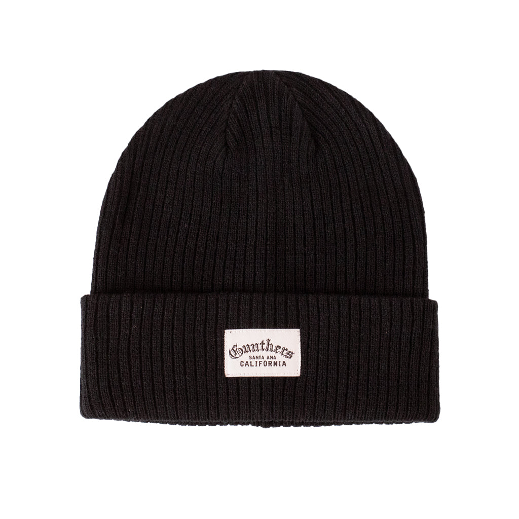 Black beanie with a label on a white background