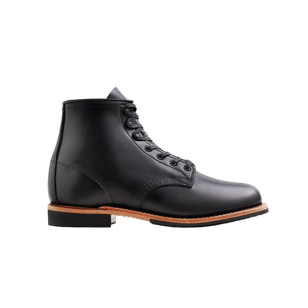 Black leather boot with brown sole on a white background