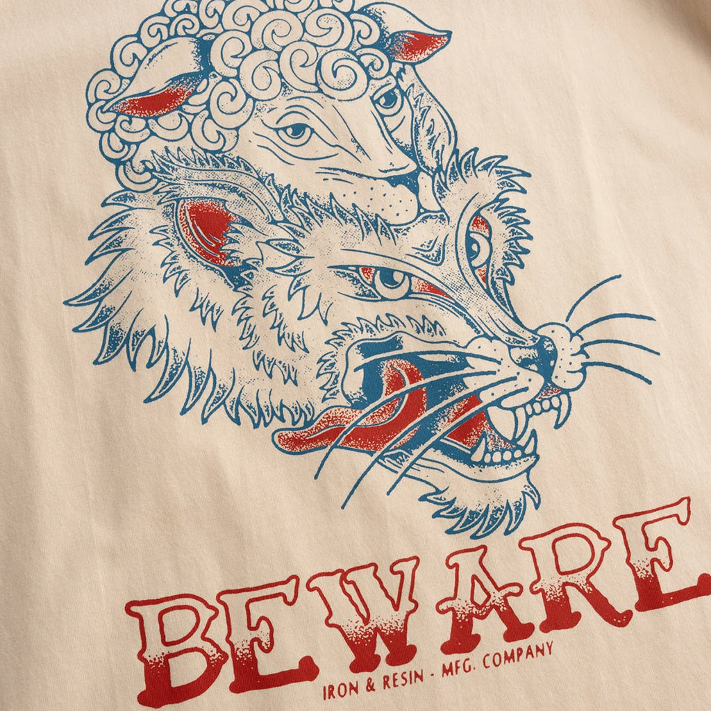 Beige fabric with a graphic of a wolf and ram's head and 'Beware' text.