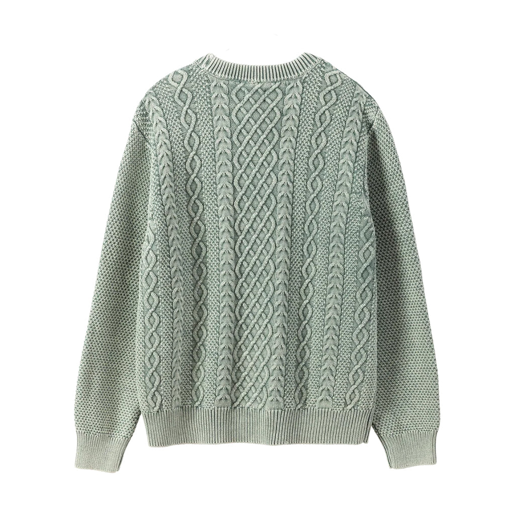 Green cable knit sweater on a white background