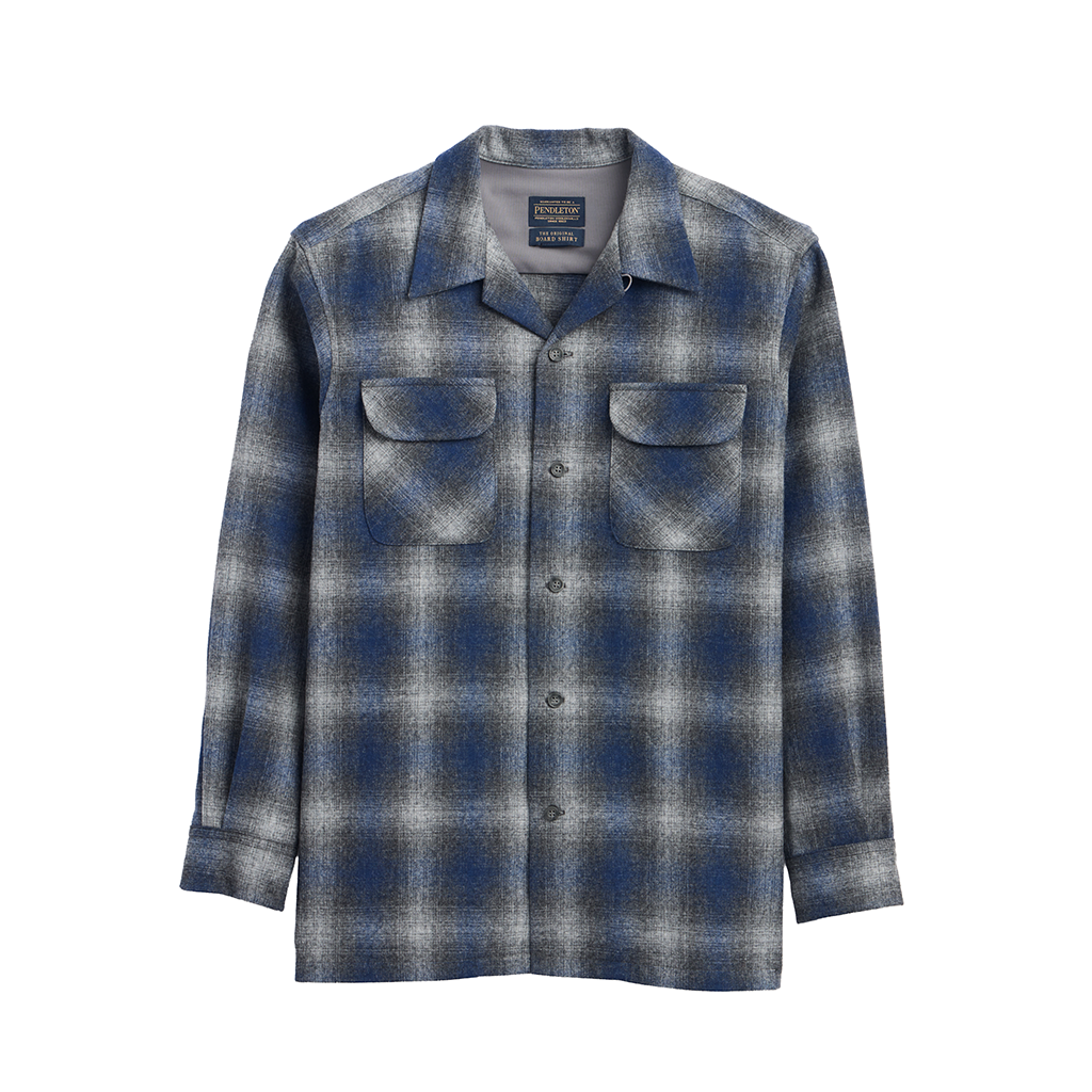 A long-sleeve button-up flannel shirt with a blue, gray, and white plaid pattern, featuring two chest pockets and a spread collar, shown against a plain white background.