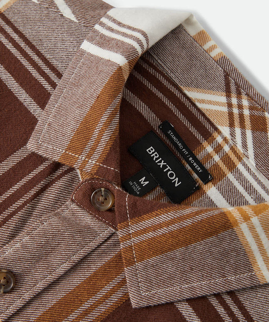 Close-up of a plaid shirt with a Brixton label on a white background