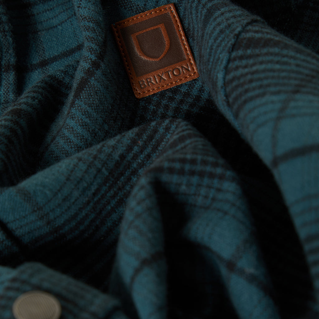Close up of leather brixton patch on the front pocket of the jacket.