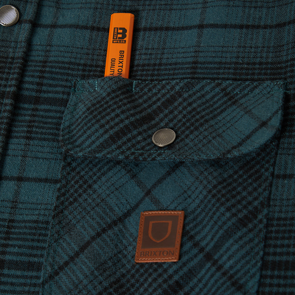 Close up of snap button and pencil holder on front of the brixton jacket