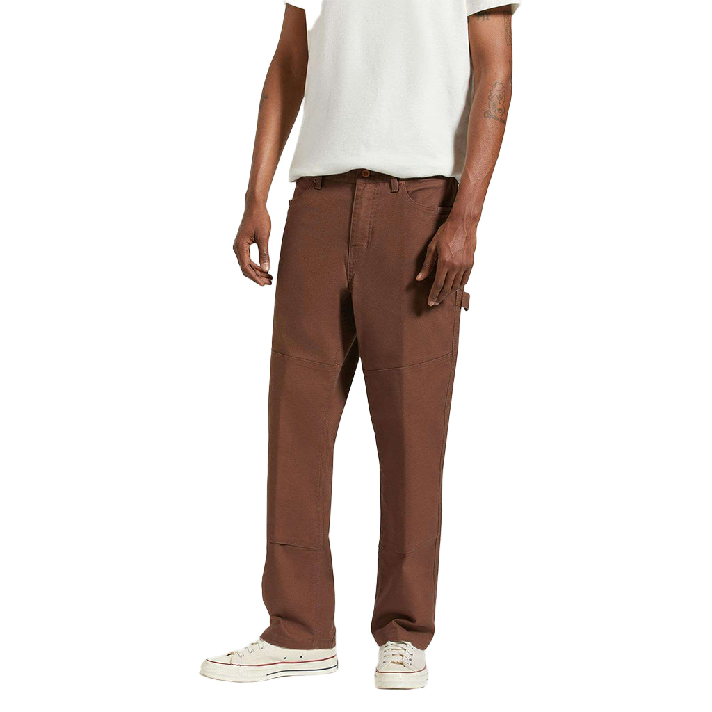 Brown pants worn by a person on a white background