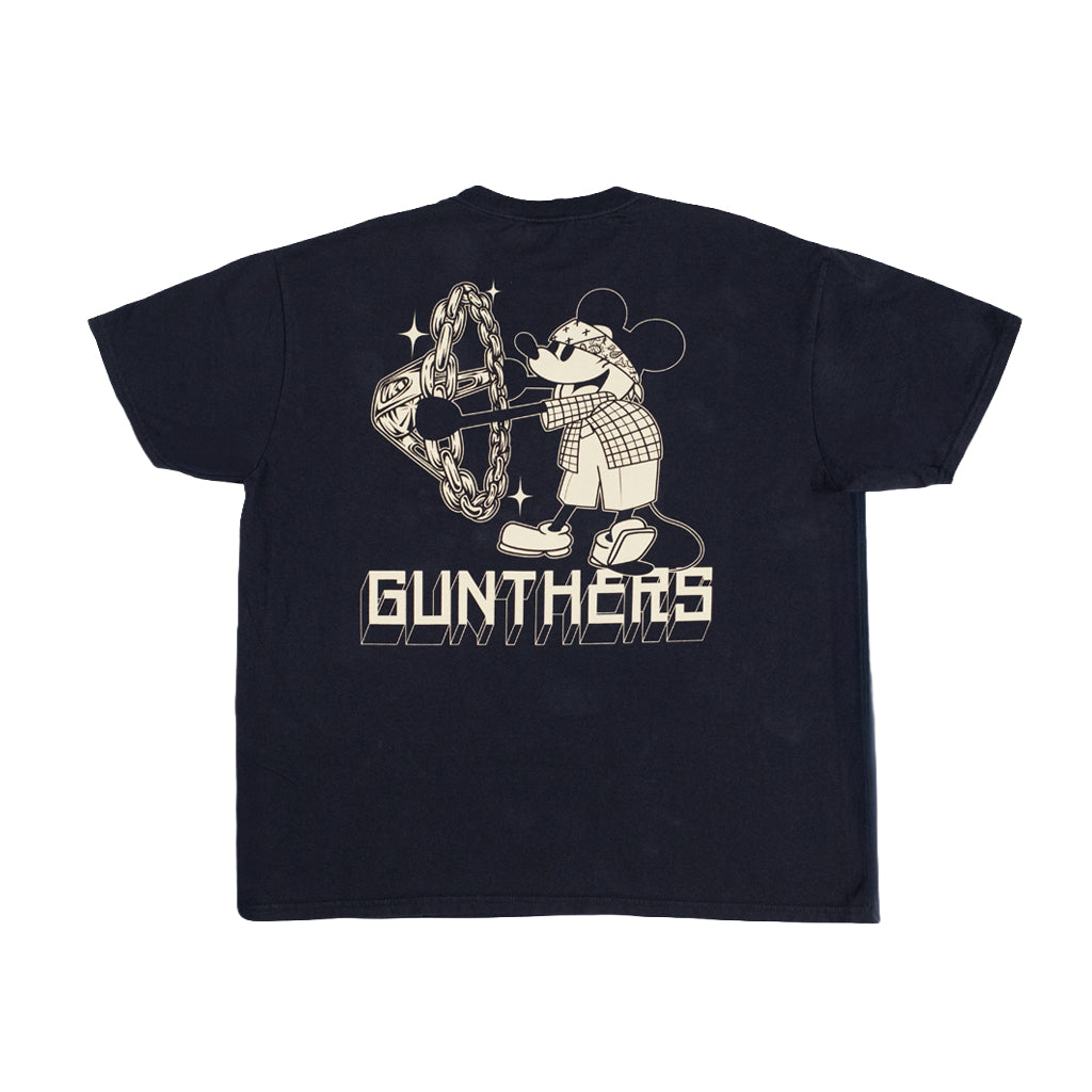A black short-sleeve t-shirt shown from the back, featuring a large cream-colored graphic of a cartoon mouse wearing a plaid shirt and holding a chainsaw, with the word 'GUNTHERS' printed below.