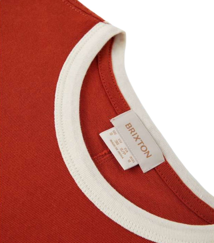 Close-up of a red shirt with a white collar and Brixton label.