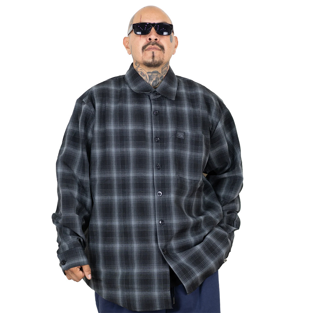 Man wearing a gray plaid shirt on a white background
