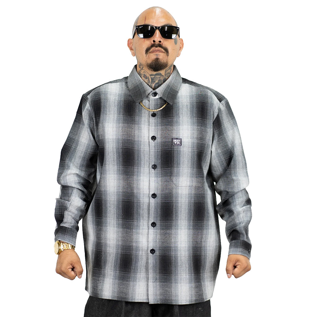 Man wearing a plaid shirt with a brand logo on a white background