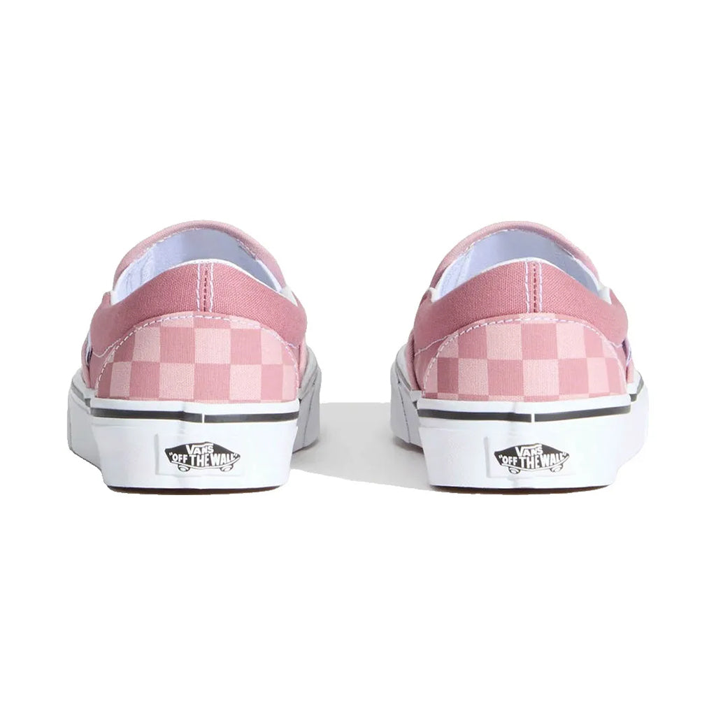 Pink checkered Vans shoes on a white background