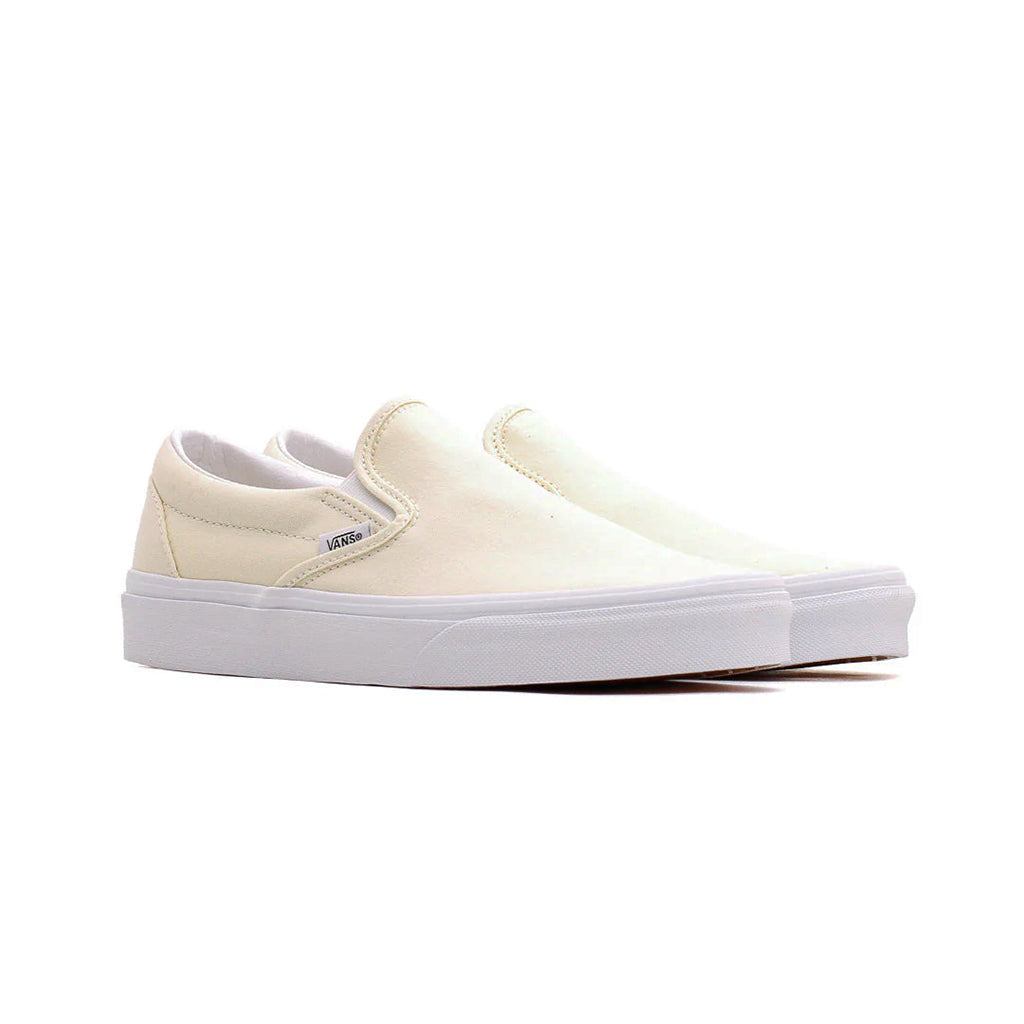 White slip-on sneakers with a visible brand logo on a white background