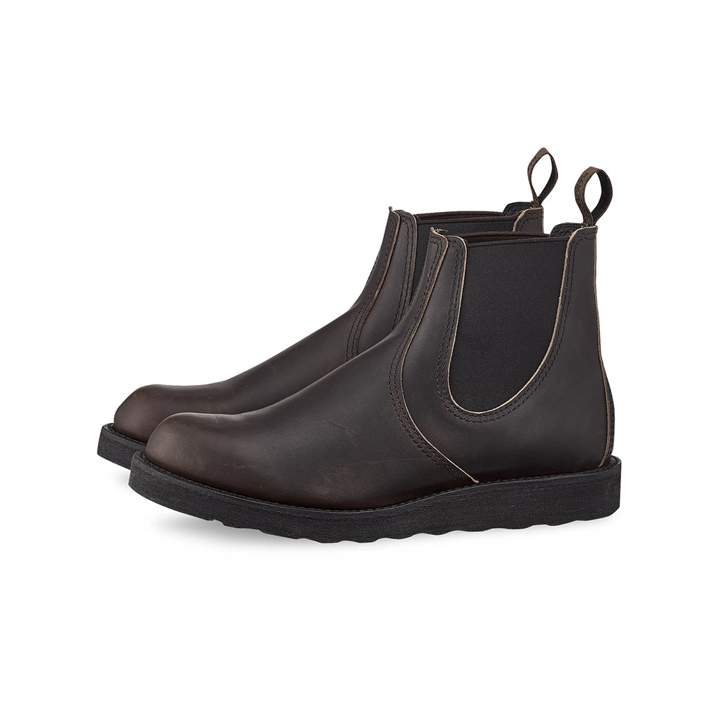 Pair of dark brown leather Chelsea boots on a white background