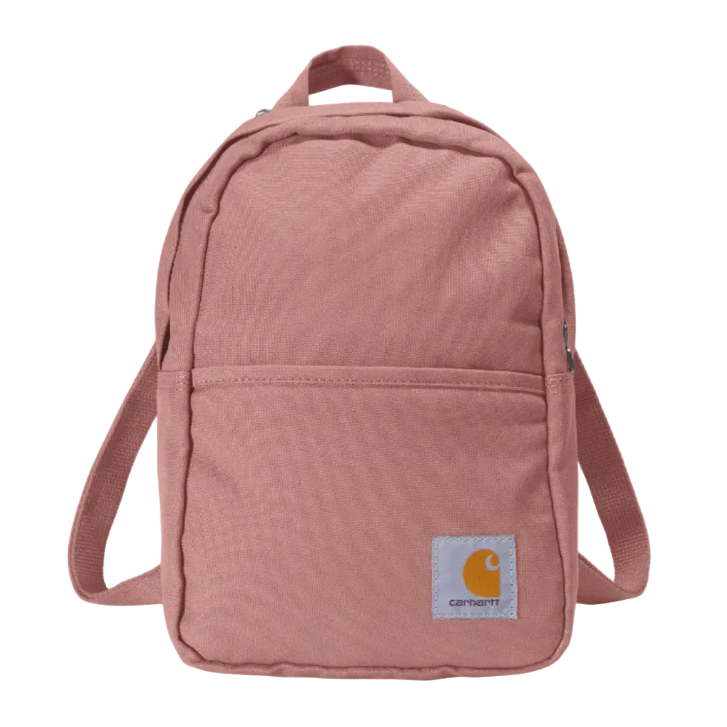 A dusty rose pink Carhartt canvas backpack with a front zippered pocket and a signature yellow Carhartt logo patch on the bottom right, shown against a plain white background.