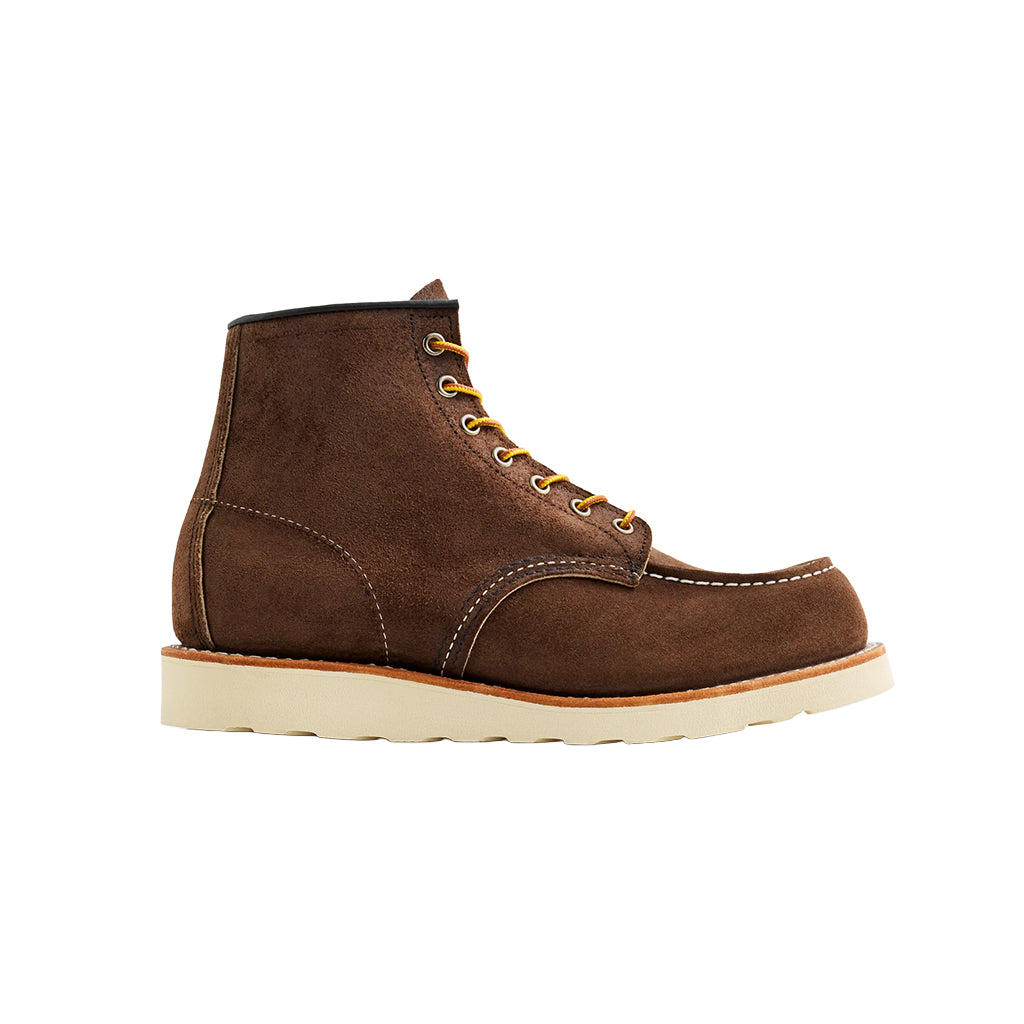 Brown leather boot with yellow laces on a white background