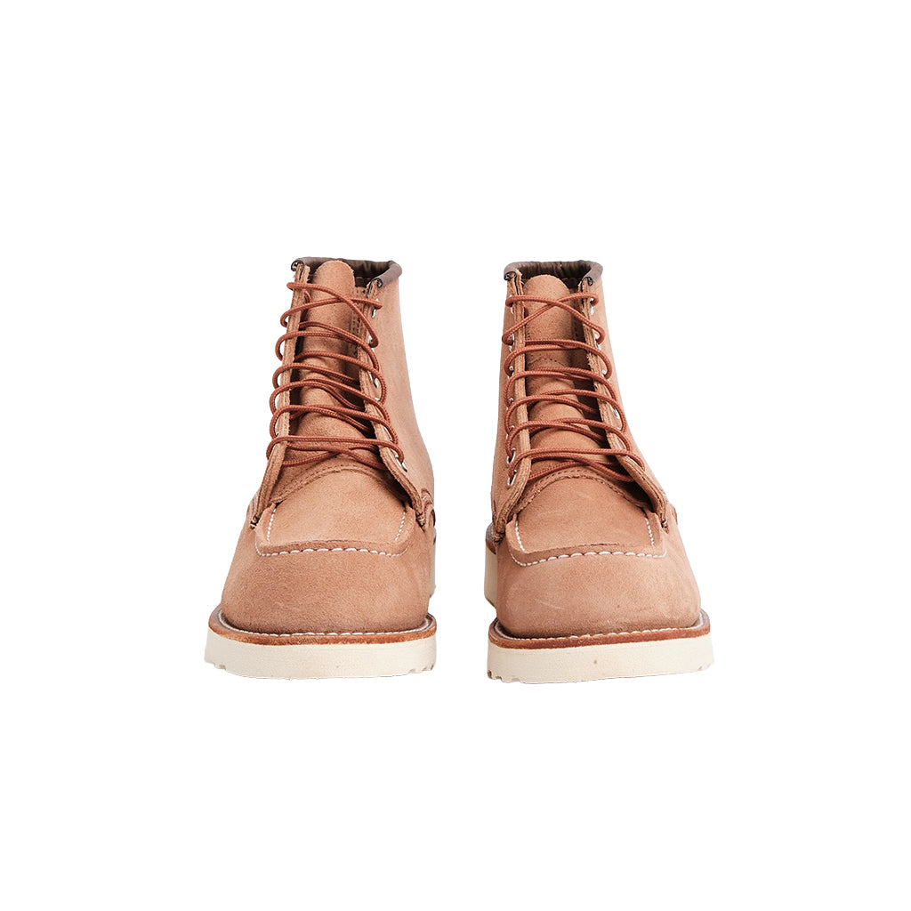 Pair of light pink leather boots on a white background