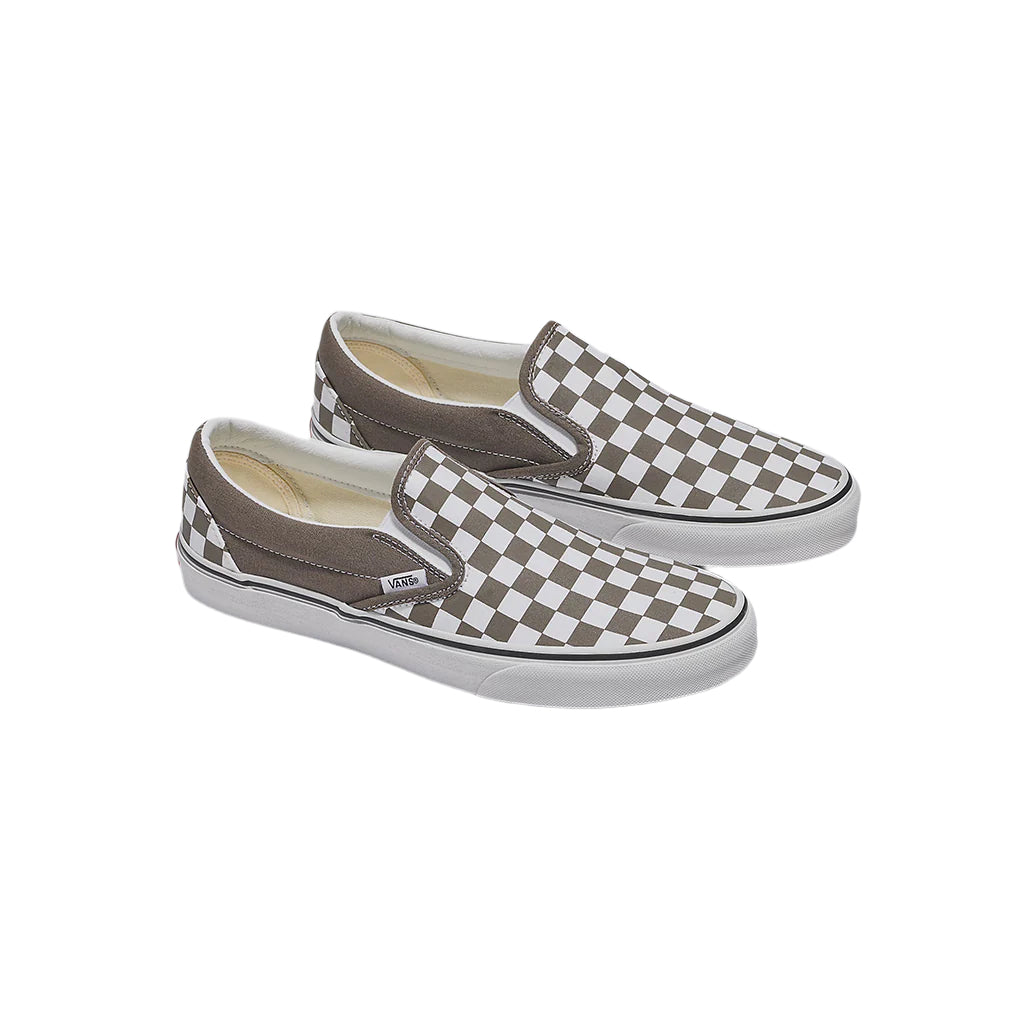 Pair of brown checkered slip-on shoes on a light gray background