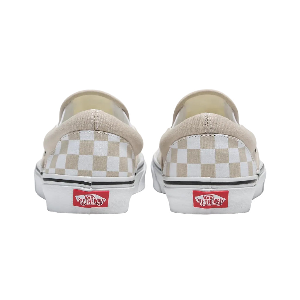Pair of Vans slip-on shoes with beige and white checkered pattern on a white background