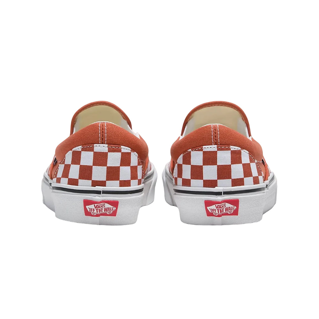 Pair of Vans slip-on shoes with checkered pattern and red logo on a white background