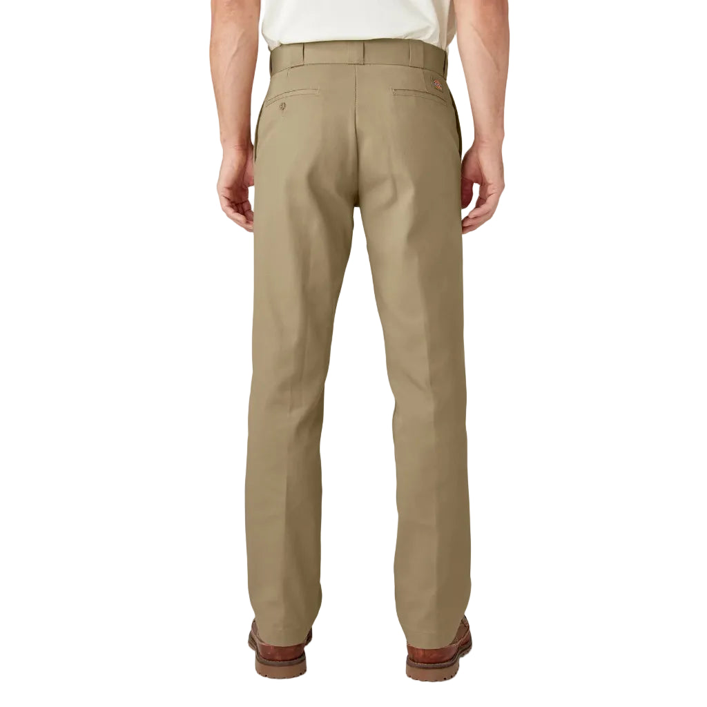 Beige pants worn by a person on a white background