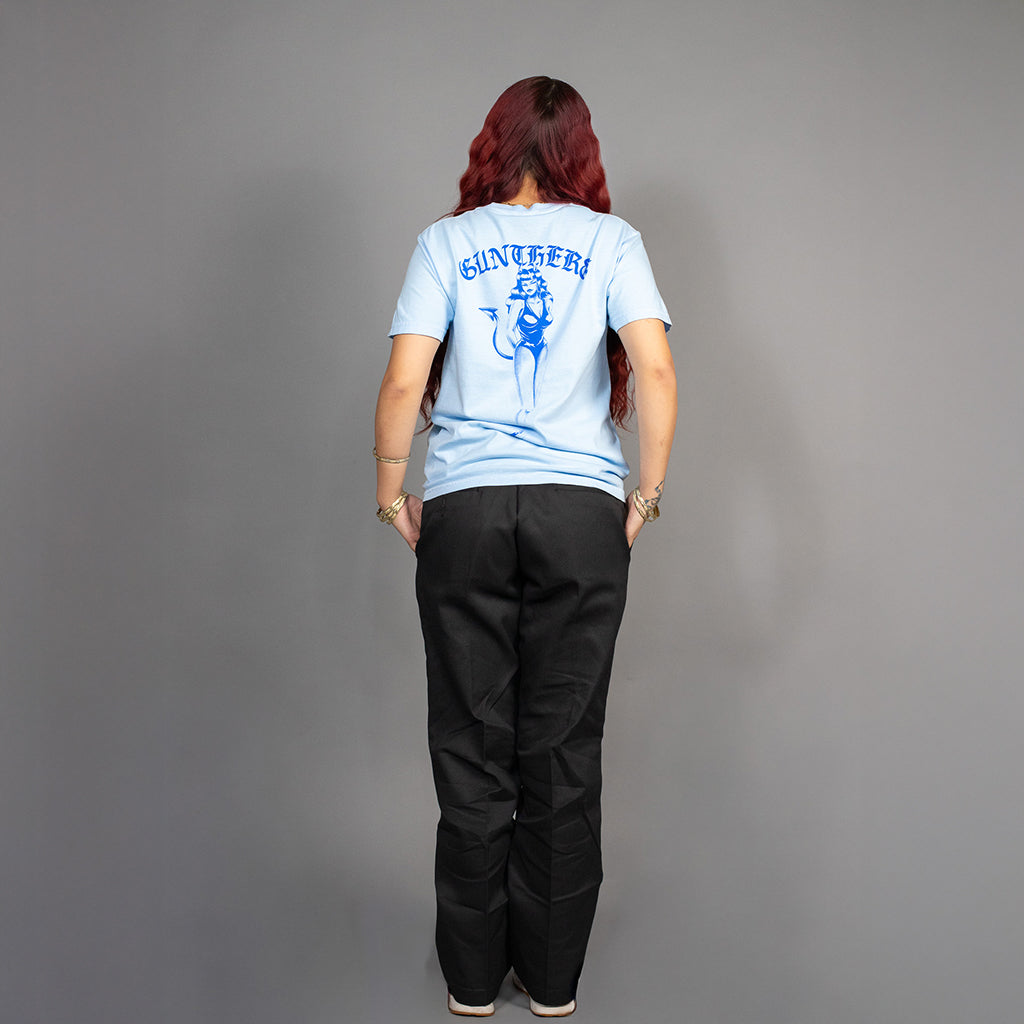 Person wearing a light blue t-shirt with a graphic design on the back, standing against a gray background.