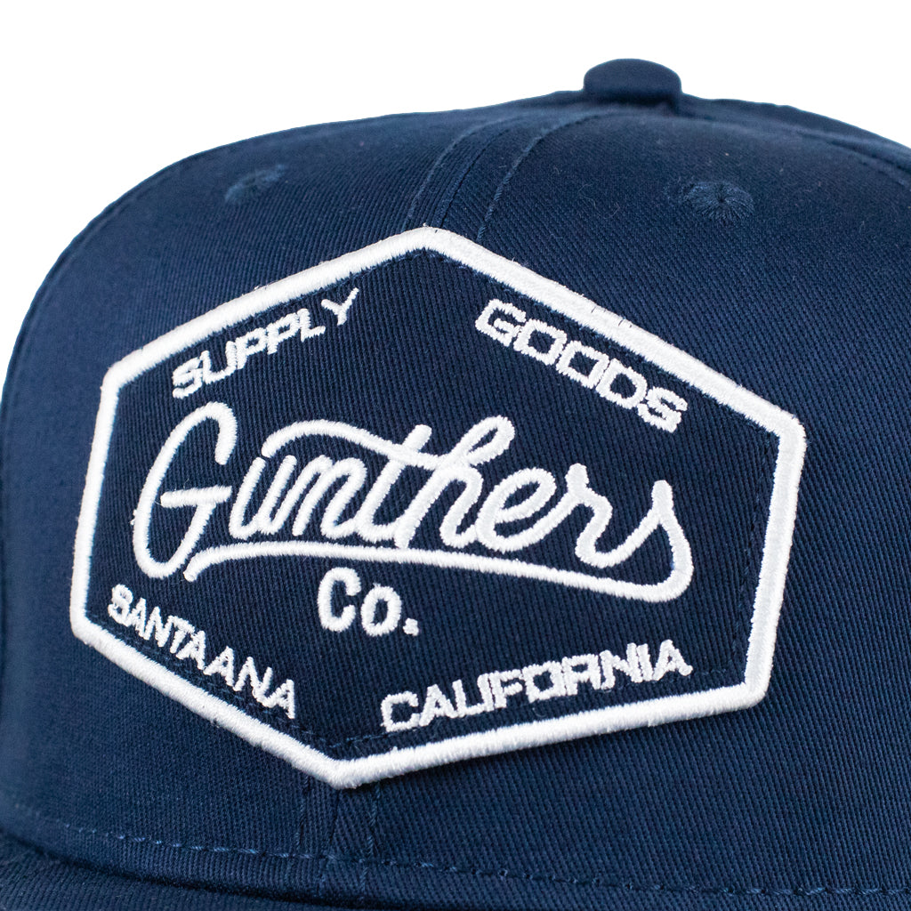 Navy blue cap with white embroidered logo on a white background