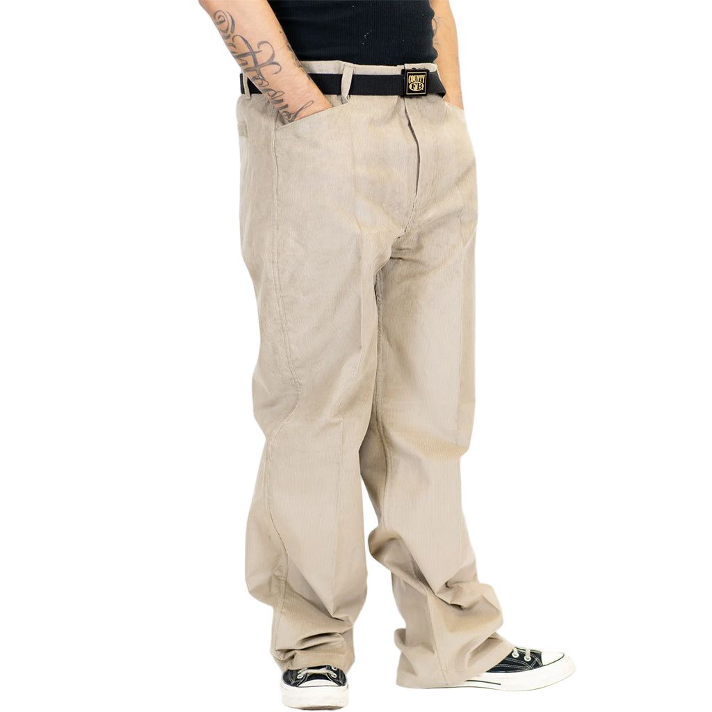 Beige pants worn by a person on a white background