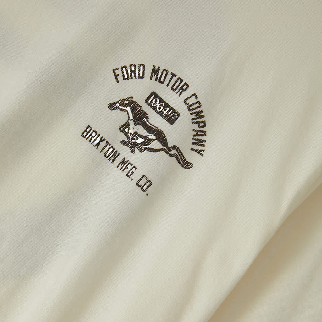 Close-up of an off-white fabric surface with a dark brown printed logo reading 'FORD MOTOR COMPANY' and 'BRIXTON MFG. CO.